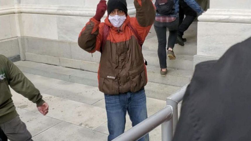 Karthik Ramakrishnan wears a surgical mask and beats a drum